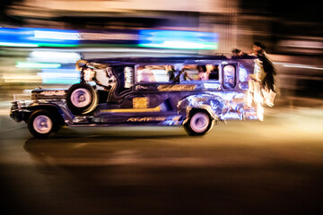 the iconic Philippine jeepney, the king of the road in Metro manila. Jeepney speeding in the streets of Manila.