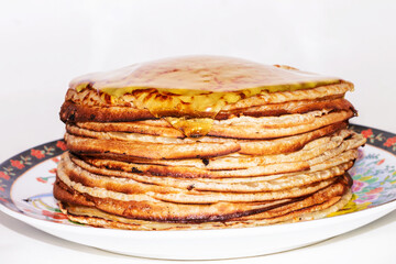 Pancakes with honey on a white background