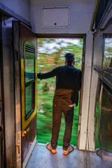 Obraz na płótnie Canvas passenger standing at running train gate risking his life