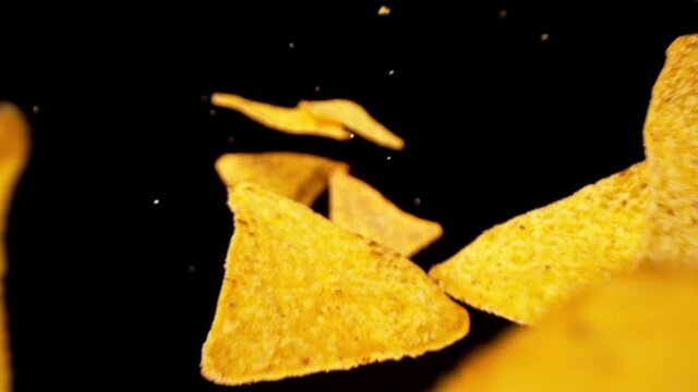 Super Slow Motion Shot of Tortilla Chips Falling on Black Background, 1000fps.