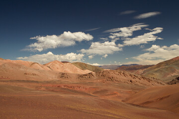 Fototapeta na wymiar Arid desert landscape high in the Andes mountain range. View of the dunes, brown land and colorful mountains in Laguna Brava, La Rioja, Argentina.