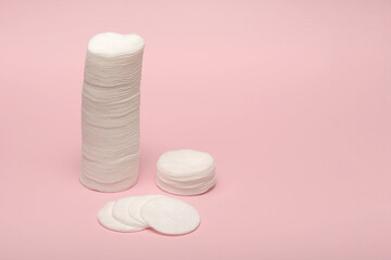 Cotton pads for removing makeup. On a pink background.