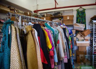 Inside vintage thrift clothing store with fashionable clothing & accessories  