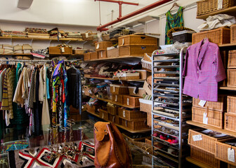 Inside vintage thrift clothing store with fashionable clothing & accessories  