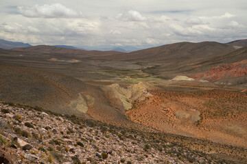 The arid desert. Aerial view of the dry land, valley and mountains under a beautiful sky high in the Andes mountain range.