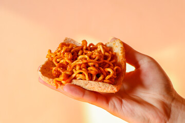 close up of a hand holding a pasta