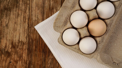 White eggs on wooden background. Easter and healthy food breakfast cooking concept