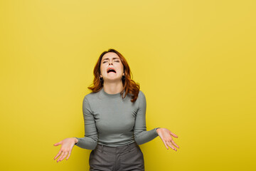 frustrated woman whining and gesturing isolated on yellow - obrazy, fototapety, plakaty