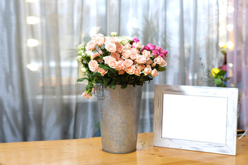 a large bucket with a bouquet of flowers on a shop window of ss white wooden frame with space for...
