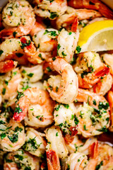Lemon garlic butter srimp in a white frying pan.top view