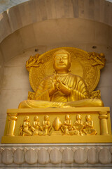 Budhha meditating golden statue isolated in details from unique perspective