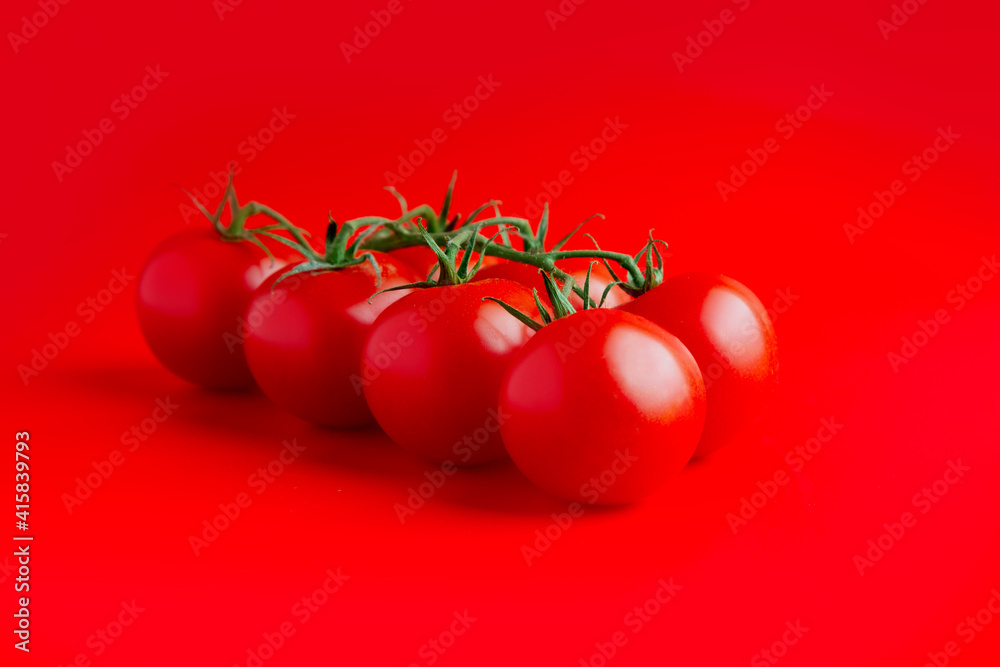 Wall mural Bunch of fresh, red cherry tomatoes with green stems. soft light. copy space. top view
