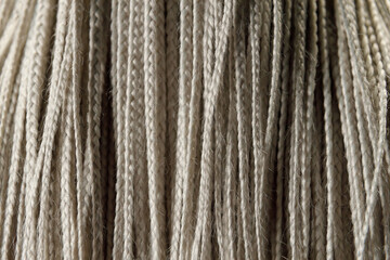 white hair in braids. Trendy and fashionable hairstyle, close up. Weaving technique.