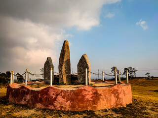 Standing sacred stone monoliths with bright blue sky and grass from different perspective