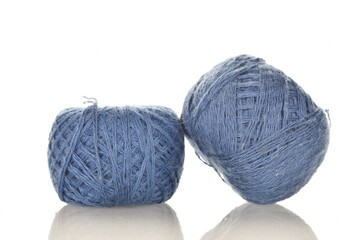 Two spools of blue thread, close-up, isolated on white.