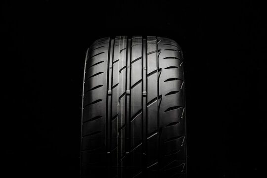 KRASNOYARSK, Russia February 22, 2021: New tires Bridgestone potenza adrenalin RE 004. front view on a black background