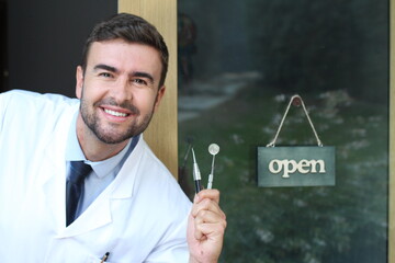 Friendly dentist with open sign 