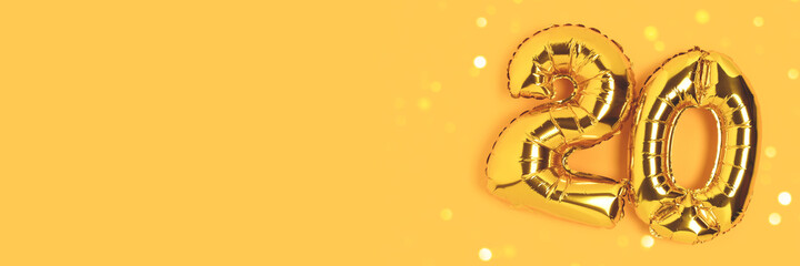 Banner with number 20 golden balloons with copy space. Twenty years anniversary celebration concept...