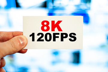 Fototapeta premium 8K 120FPS man holding screen resolution concept on paper