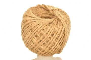 One spool of jute thread, close-up, isolated on white.