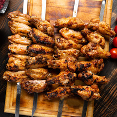 grilled or barbecue chicken wings skewer on board