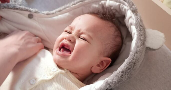 Mom undresses a little boy on the bed. Medicine, healthcare, family, innocence, pediatrics happiness infant concepts. slow motion