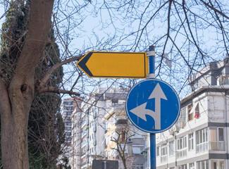circular left turn, yellow color street signpost in the neighborhood