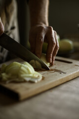 Male hands cutting onions