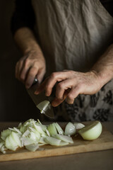 Male hands cutting onions