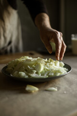 Male hands cutting onions