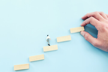 Business image of arranging wood blocks stacking as step stairs. Success and development concept
