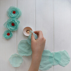 How to make a flower brooch from organza. Step 3. Burn each circle above the candle along the edge....