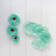 How to make a flower brooch from organza. Step 4. Delicate flower petals are ready. DIY concept....