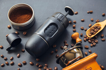 espresso coffee machine, cup and bean on black wooden table background. top view