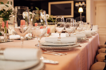 Luxurious restaurant. Luxurious interior, white tables, serving dishes and glasses for guests