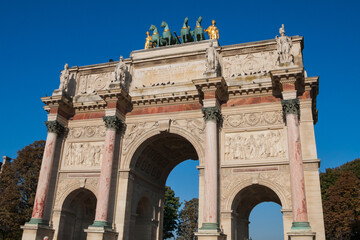 Fototapeta na wymiar Arc de Triomphe du Carrousel (Triumphal Arch at Carrousel Place) monument is a tribute to Napoleon's military victories in Paris, France on an autumn day with clear blue sky