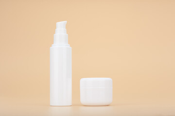 Set of face cream and under eye cream against beige background. Concept of beauty products for daily skin care