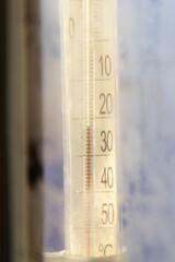  -23C temperature on analog outdoor Thermometer scale on frosty glass at cold sunny Winter day, weather forecast illustration