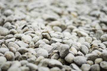 background of stones in frost the beginning of spring