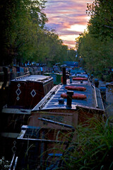Fototapeta na wymiar boat houses in a canal in Little Venice in West London.