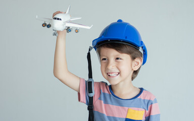 Little boy is playing model of airplane