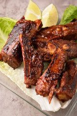 closeup of roasted pork ribs with barbecue sauce and caramelized with honey. Tasty homemade snack or small business ow