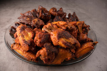 plate of ribs and roast chicken appetizer on gray background