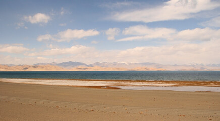 View from the shores of Karakul lake at sunrise, with Zulumart snow-capped mountain range in the background, Murghab district, Gorno-Badakshan, in the Pamir region of Tajikistan
