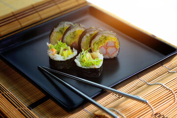 sushi roll on a black plate ready to be served