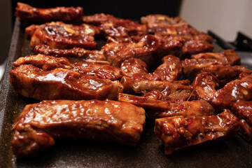 closeup of roasted pork ribs with barbecue sauce and caramelized with honey. Tasty homemade snack or small business ow