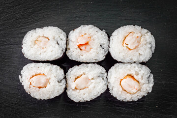 appetizing sushi shrimp maki roll on a black stone plate © Narsil