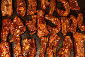 closeup of roasted pork ribs with barbecue sauce and caramelized with honey. Tasty homemade snack or small business ow