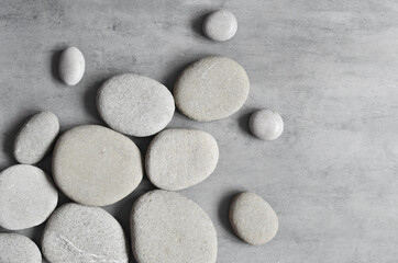 Flat lay composition with spa stones on grey background.