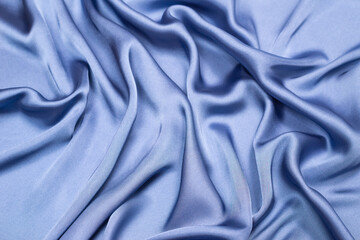 Obraz premium Blue silk or satin luxury fabric texture. Top view.